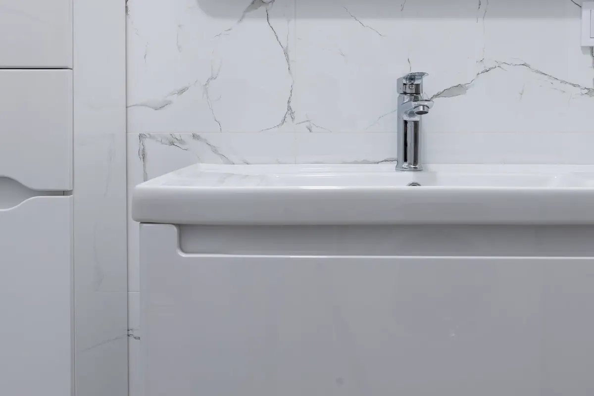 Modern bathroom basin with a chrome mixer tap
