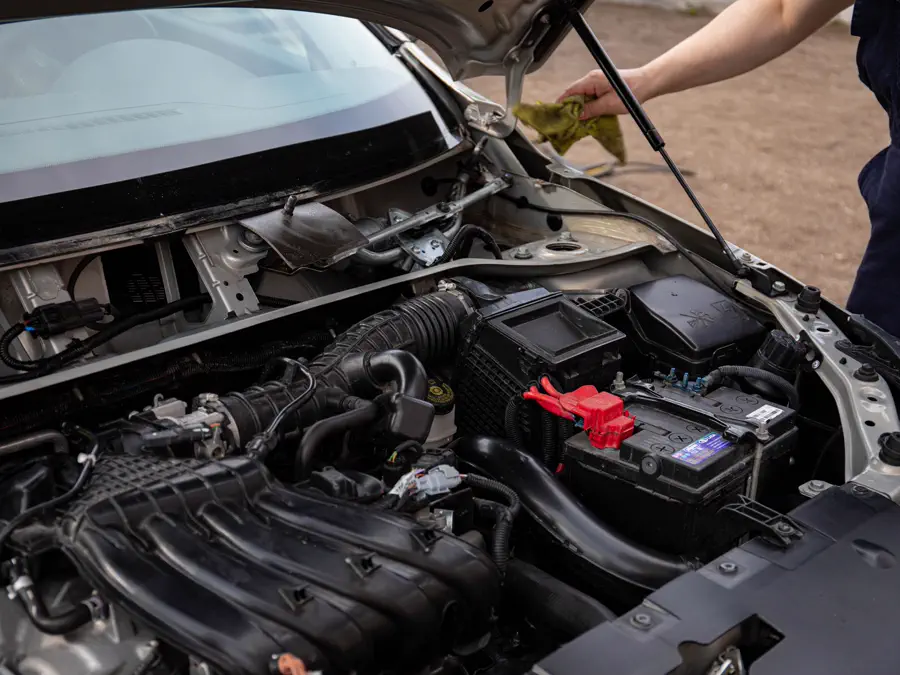 An engine bay with the battery and wiring visible.